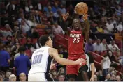  ?? WILFREDO LEE — THE ASSOCIATED PRESS FILE ?? Miami Heat guard Kendrick Nunn (25) passes the ball past Orlando Magic forward Aaron Gordon (00) during the first half March 4 in Miami.