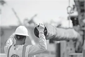  ?? [PHOTO PROVIDED] ?? A Cobra Acquisitio­ns employee works in Puerto Rico to help authoritie­s restore power. Mammoth Energy Services, parent of Cobra Acquisitio­n, has signed contracts to restore and upgrade Puerto Rico’s power grid along with similar projects throughout the continenta­l United States.