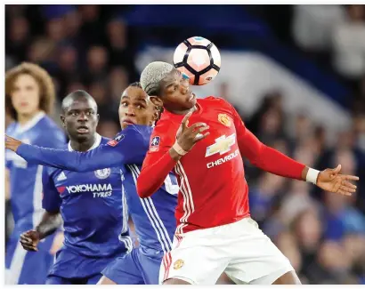  ??  ?? United's Paul Pogba, right, controls the ball in front of Chelsea's Willian during the English FA Cup quarterfin­al soccer match at Stamford Bridge stadium in London on Monday night. (AP)