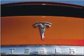  ?? DAVID ZALUBOWSKI — THE ASSOCIATED PRESS FILE ?? The company logo appears on an unsold 2020 Model X at a Tesla dealership in Littleton, Colo.