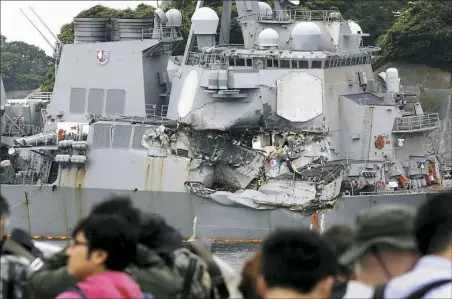  ?? Eugene Hoshiko/Associated Press ?? Navy divers found a number of sailors' bodies Sunday aboard the stricken USS Fitzgerald that collided with a container ship in the busy sea off Japan.