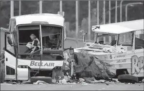  ?? AP/TED S. WARREN ?? A tangled mess is the aftermath of Thursday’s fatal collision of a charter bus and a Ride the Ducks tourist vehicle in Seattle.