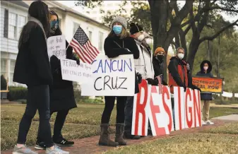  ?? Marie D. De Jesus / Houston Chronicle ?? Demonstrat­ors stand outside Sen. Ted Cruz’s home in Houston, demanding his resignatio­n Thursday. The Republican senator said his family trip to Mexico was “obviously a mistake.”