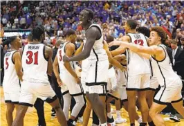  ?? K.C. ALFRED U-T ?? Aztecs’ Aguek Arop (center), celebratin­g with teammates, is from south Omaha, Neb., and grew up rooting for Creighton, but he doesn’t feel too bad for Bluejays.