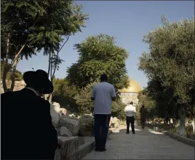  ?? AP PHOTO/MAYA ALLERUZZO ?? Religious Jews face the Temple Mount, known to Muslims as the Noble Sanctuary, in the Old City of Jerusalem, Monday, Aug. 2, 2021. Jewish prayers at Jerusalem’s most sensitive holy site, known to Jews as the Temple Mount and to Muslims as the Noble Sanctuary, were once unthinkabl­e. But they have quietly become the norm in recent years, defying longstandi­ng convention, straining a delicate status quo and raising fears that they could trigger a new wave of violence in the Middle East.