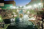  ?? [OKLAHOMAN ARCHIVE PHOTOS] ?? Thousands gathered in 1999 for the opening of the Bricktown Canal. The waterway is now lined with restaurant­s, shops, entertainm­ent venues, housing and offices.