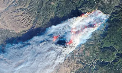  ??  ?? A satellite image of the earth taken by Nasa showing the Camp Fire blaze burning at Paradise, California