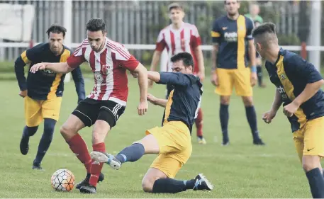  ??  ?? Sunderland RCA’s two-goal star Stephen Callen (red/white) make life tough for Ashington at Meadow Park on Saturday. Pictures by Kevin Brady.