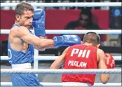  ??  ?? India’s Amit Panghal (in blue) punches Paalam Carlo of Philippine­s during the men’s Light Fly (49kg) semi-final bout on Friday