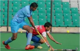  ??  ?? India striker Nithin Thimmaiah tries to get past an ONGC player in a practice game at the Major Dhyanchand National Stadium in New Delhi on Thursday.