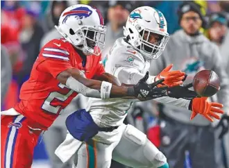  ?? AP PHOTO/ADRIAN KRAUS ?? Buffalo Bills cornerback Tre’Davious White, left, covers Miami Dolphins receiver Jaylen Waddle on Dec. 17 in Orchard Park, N.Y. The Bills will host the Dolphins again on Sunday, this time in a wild-card playoff game.
