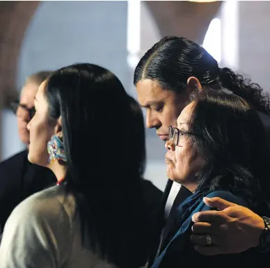  ?? JUSTIN TANG / THE CANADIAN PRESS ?? Sheldon Wuttunee puts his arm around Debbie Baptiste, mother of Colten Boushie, as the family speak to reporters in the foyer of the House of Commons Tuesday after a day of meetings with the prime minister and justice minister.