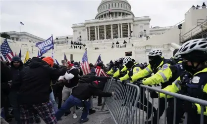  ?? Photograph: Julio Cortez/AP ?? Trump supporters try to break through a police barrier at the Capitol in Washington on 6 January.