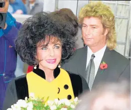  ?? GILL ALLEN/AP ?? In this Nov. 5, 1991 file photo, Elizabeth Taylor arrives at a restaurant accompanie­d by her husband Larry Fortensky in London.