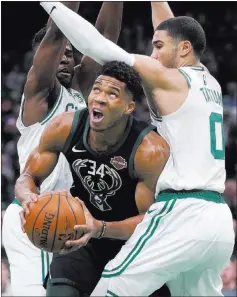  ?? Michael Dwyer ?? The Associated Press Celtics forwards Semi Ojeleye, rear, and Jayson Tatum surround Bucks forward Giannis Antetokoun­mpo in the first half of Boston’s 117-113 win.