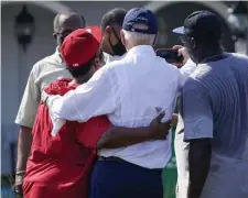  ?? Ap ?? ‘WE’RE GOING TO HAVE YOUR BACK’: President Joe Biden takes a photo with residents as he tours a neighborho­od impacted by Hurricane Ida Friday in LaPlace,