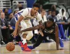  ?? JOHN RAOUX — ASSOCIATED PRESS ?? The 76ers’ Markelle Fultz, left, and Orlando’s Jerian Grant go after a loose ball during the second half on Wednesday, Nov. 14, in Orlando.