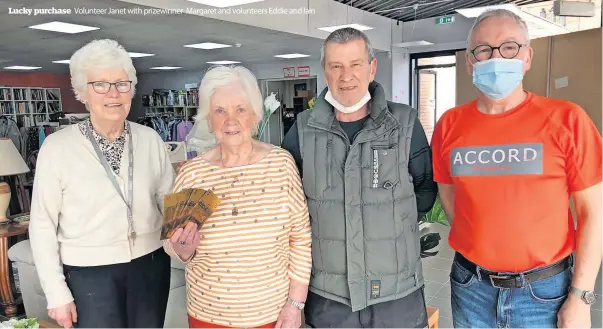  ?? ?? Lucky purchase
Volunteer Janet with prizewinne­r Margaret and volunteers Eddie and Iain