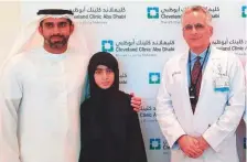  ?? Samihah Zaman/Gulf News ?? ■
Alia with her father (left) and Dr Arif Khan at Cleveland Clinic Abu Dhabi. Her sister Hessa also received the therapy.