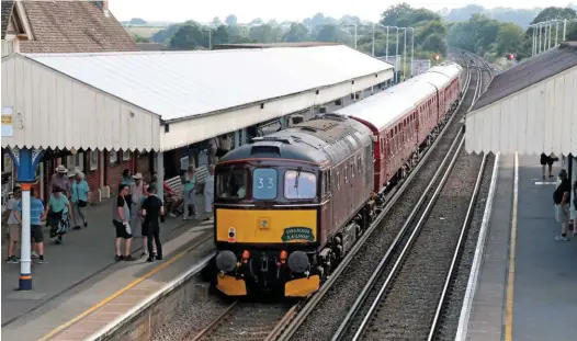  ?? ANDREW P.M. WRIGHT. ?? A West Coast Railways Class 33 locomotive leads a Swanage Railway shuttle from Swanage into Wareham on July 6 2017. During the summer of 2017, the railway had to hire in stock and locomotive­s from WCR to cover for its own DMUs, which weren’t ready in time.