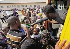  ??  ?? Fleeing violence A medical officer hands out medicine to people fleeing violence in Central African Republic, at an airport in Abuja. Nigeria airlifted 1,113 fleeing refugees over the weekend.
Reuters