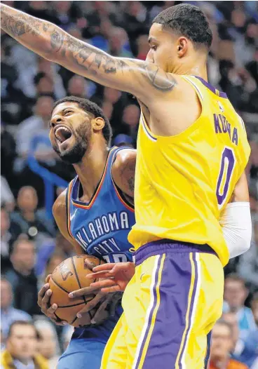  ?? [PHOTO BY NATE BILLINGS, THE OKLAHOMAN] ?? Oklahoma City’s Paul George tries to score against Los Angeles’ Kyle Kuzma during Thursday’s game at Chesapeake Energy Arena.