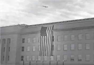  ?? MARK WILSON, GETTY IMAGES ?? A flag is draped over the Pentagon, which was struck by one of the hijacked jets 15 years ago.