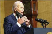  ?? ANDREW HARNIK / POOL ?? President Joe Biden takes off his face mask as he begins to speak from the Treaty Room in the White House on Wednesday about the withdrawal of the remainder of U.S. troops from Afghanista­n.