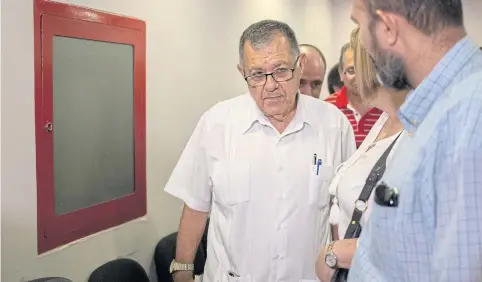  ?? AP ?? Cuban Transport Minister Adel Yzquierdo, centre, leaves after speaking to reporters about Friday’s crash at the Jose Marti Internatio­nal Airport in Havana, Cuba.