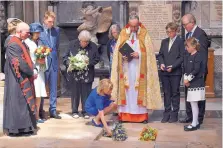  ?? BEN STANSALL/PA ?? Lucy Hawking lays flowers as the ashes of her father, Professor Stephen Hawking, are laid to rest during his memorial service at Westminste­r Abbey in London Friday.