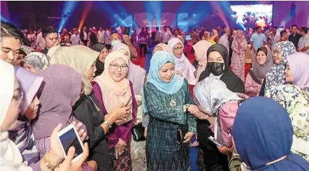  ?? — Photo from The royal Johor Facebook page. ?? Hope for the hopeless: raja Zarith Sofiah (in blue headscarf) being greeted by guests at the Tunku Laksamana Johor cancer Foundation rays of Light charity dinner held at the Persada Johor internatio­nal convention centre in Johor baru.