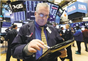  ?? Richard Drew / Associated Press ?? Trader Frank O’Connell works the floor of the New York Stock Exchange on Friday. Analysts have been speculatin­g a lot about the strength of corporate America, and earnings reports should offer more clarity.