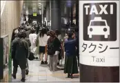  ??  ?? People queue up for taxi as train services are suspended following an earthquake in Sendai, Miyagi prefecture, Japan Saturday.