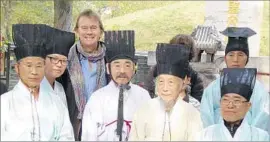  ?? PBS ?? HOST MICHAEL WOOD, with Korean scholars at the Confucian cemetery in Qufu, China, provides his own on-the-ground perspectiv­e in the documentar­y.