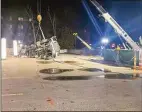  ?? Trevor Ballantyne/Hearst Connecticu­t Media ?? Cranes work to lift a truck that fell through a parking garage on Crosby Street in Danbury on Monday.