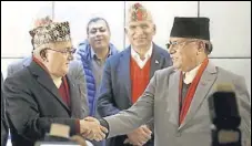  ?? REUTERS FILE ?? Chairman of Communist Party of Nepal (UML) KP Oli (left) greets Communist Party of Nepal (Maoist Centre) chairman Prachanda. The alliance has a very strong Chinese backing.