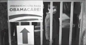  ??  ?? A boy waits in line at a health insurance enrollment event in Cudahy, California.
(Photo: Reuters.com)