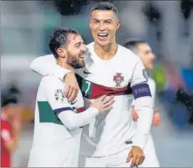  ?? AFP ?? Portugal's Cristiano Ronaldo (R) celebrates with Bernardo Silva after scoring against Luxembourg in their Euro qualifying match in Luxembourg on Sunday.