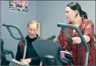  ?? NEWS PHOTO MO CRANKER ?? Trainer Todd Schneider works with Classic Loser contestant McKenna Berg Friday at the Caloric Responsibi­lity gym. Schneider says contestant­s have lost approximat­ely 100 pounds combined through the first week of the competitio­n.