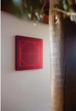  ??  ?? ABOVE MIDDLE The first work the couple bought after opening the gallery in 2018 was this one by Kāryn Taylor, Square Circle Halved. “It’s the first red work I saw of Kāryn’s and we both found it completely absorbing,” says Jhana. “The red of the work fits with the exposed timber of our house and sits between two large windows that frame our view of the rockpools.”