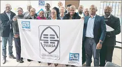 ?? (Courtesy pic) ?? Eswatini Wire staff and SWASA representa­tives holding the ISO 9001 flag.