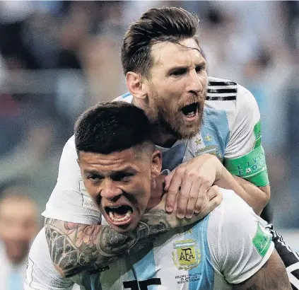  ?? PHOTO: REUTERS ?? He ain’t heavy . . . Argentina defender Marcos Rojo (front) celebrates scoring his side’s second goal with teammate Lionel Messi in the World Cup clash against Nigeria in St Petersburg yesterday. Rojo’s late goal gave Argentina a 21 win in the group...