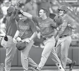  ?? Nati Harnik Associated Press ?? DEACON LIPUT (8) arrives at the plate after hitting a home run with Jonathan India (6) and Nelson Maldonado (27) aboard in the fourth inning.