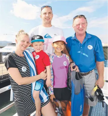  ?? Picture: JOSH WONING ?? BOATING BOUNTY: Ashlea Calvert and Hudson, 4, with Mark Moss and Kayla, 10, from Sydney and Peter Moss from Cairns on a Reef Magic Cruises trip.