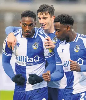  ??  ?? Brandon Hanlan, left, celebrates scoring for Rovers against Northampto­n