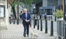  ?? HANNAH MCKAY / REUTERS ?? British Prime Minister Boris Johnson arrives at a polling station in London on Thursday to vote in the local elections.