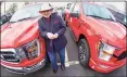  ?? Associated Press ?? Shults Ford dealership owner Richard Bazzy between two of the remaining Ford F150 pickups on the dealership lot in Wexford, Pa. Ford is warning that it expects to make half the normal number of vehicles through June.