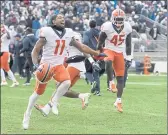  ?? BARRY REEGER — THE ASSOCIATED PRESS ?? Illinois wide receiver Carlos Sandy (11) and linebacker Khalan Tolson (45) celebrate their 20-18 victory over Penn State in the ninth overtime Saturday in State College, Pa.