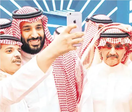  ??  ?? All smiles: Saudi Crown Prince Mohammed bin Salman (centre) posing for a selfie during the Future Investment Initiative in Riyadh