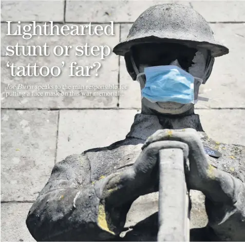  ??  ?? BEHIND THE MASK: The Fenton war memorial in Albert Square which has seen a mask fitted over the face of the soldier.